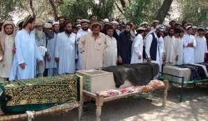 Pakistani tribesmen gather for funeral prayers before the coffins of people allegedly killed in a US drone attack, claiming that innocent civilians were killed during a June 15 strike in the North Waziristan village of Tapi, 10 kilometers away from Miranshah, on June 16, 2011 (AFP Photo)