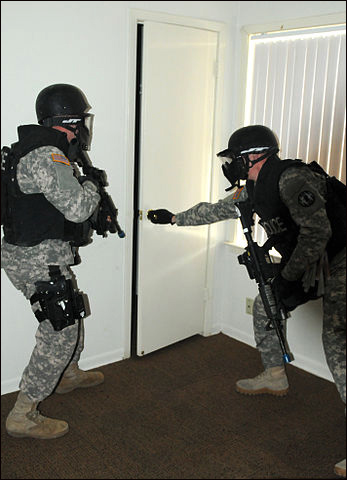 Members of the Special Reaction Team with the 178th Military Police Detachment, 89th Military Police Brigade, raid a house in Wainwright Village during a new training exercise at Fort Hood, Texas, March 5, 2013.