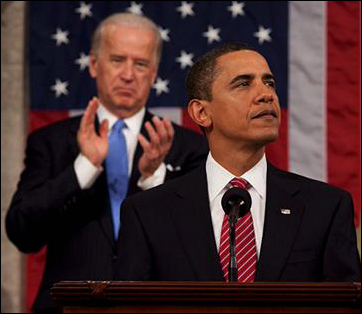 Vice President Biden stands behind President Barack Obama.